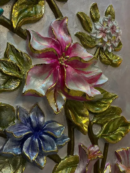 An extreme close-up of a pink and white flower, highlighting the hand-painted details and the golden edges that catch the light.