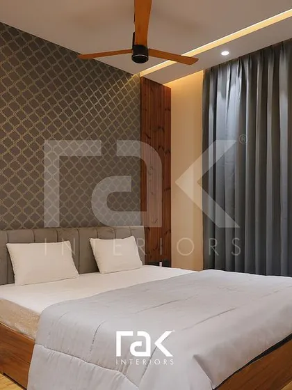 A closer look at the sophisticated bedroom with patterned wallpaper and dark wood accents.