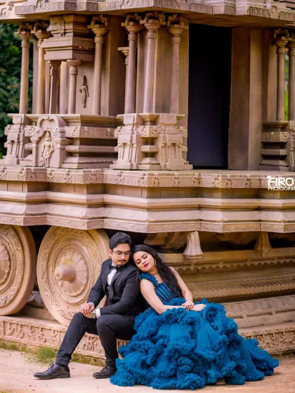A quiet, tender moment set against the magnificent stone chariot at Elements Bangalore. The texture of her ruffled blue gown contrasts beautifully with the ancient-looking stone carvings.