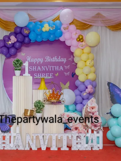 A full view of the purple butterfly-themed first birthday party.