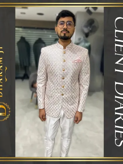 A happy client trying on his custom-made pink and white patterned Bandhgala. The perfect fit and unique design made him ready for his special event right from the final trial.