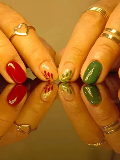 A close-up of the beautiful hand-painted holly nail art.