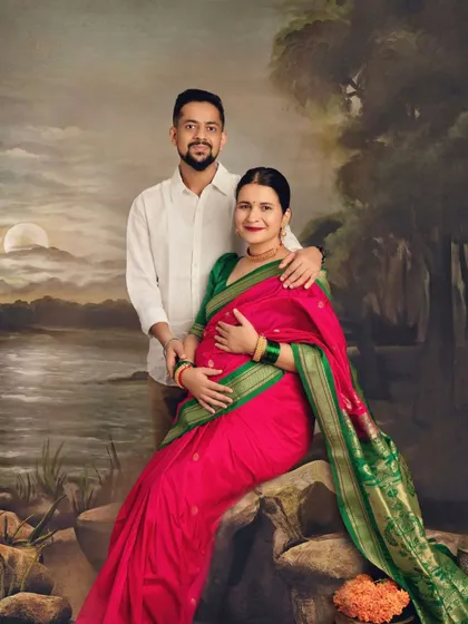 Motherhood captured with timeless, traditional elegance. This portrait, set against a classic painted backdrop, honors heritage while celebrating the new life on the way.