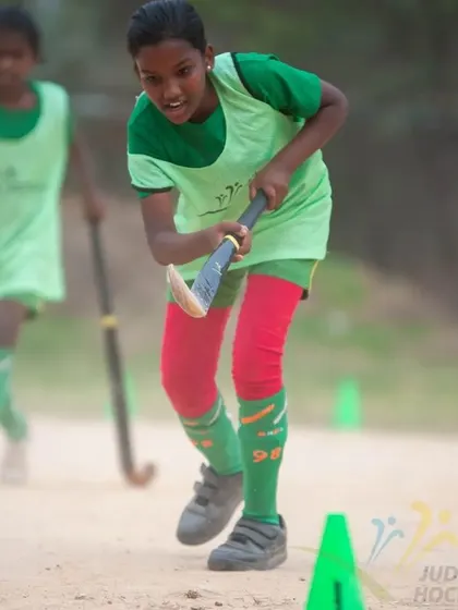 A young girl dribbles with determination during the 2022 camp. We empower all our players to be confident on the ball.