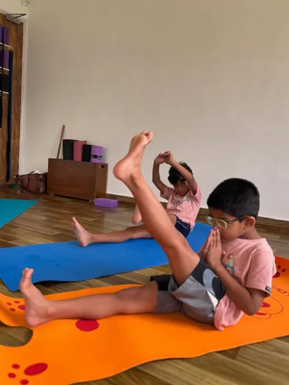 Working on leg strength and flexibility. It's wonderful to see kids so engaged and aware of their bodies during practice.