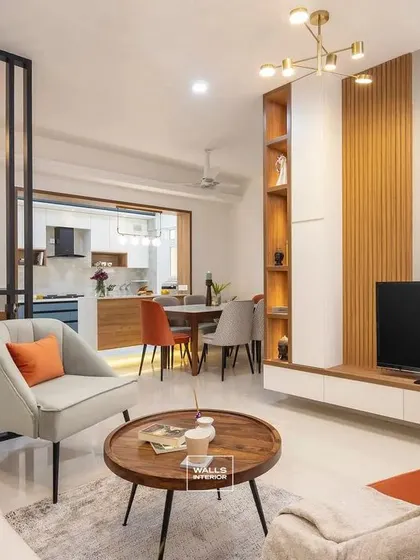 A Scandinavian-inspired living room with a simple yet elegant TV unit. The white floating console is paired with a fluted wood panel and open shelving for a light, airy look.