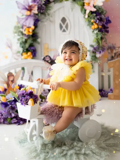 A magical first birthday in a Rapunzel-inspired enchanted forest, with yellow and purple flowers.