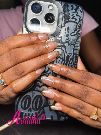 A modern and chic look featuring neutral gel extensions with a fine gold chrome line tracing the nail tip. This design is perfect for someone who loves minimalist glamour.