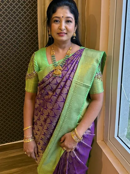 Our gorgeous client Pratima looks absolutely radiant in this designer Kanjivaram silk saree. The breathtaking combination of purple and light green is a true masterpiece, perfect for weddings and festive celebrations where you want to embrace luxury and heritage.