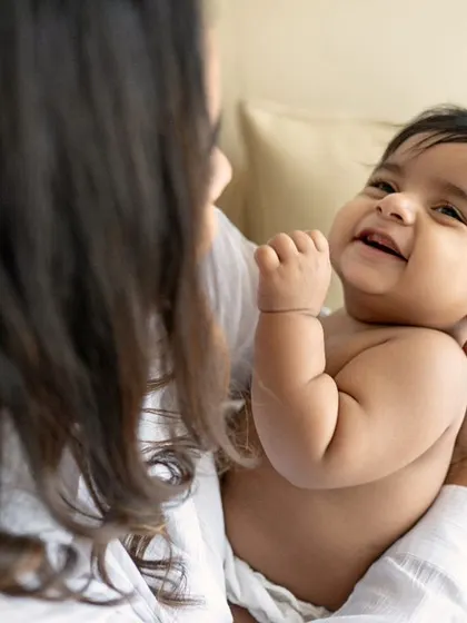 The pure happiness of a baby smiling up at their mother. These simple, loving interactions are what make for the most authentic and cherished photographs.