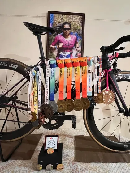 Another view of my trusty race bike and the medals we've won together. Each one represents a story of hard work and dedication. I help my athletes write their own success stories.