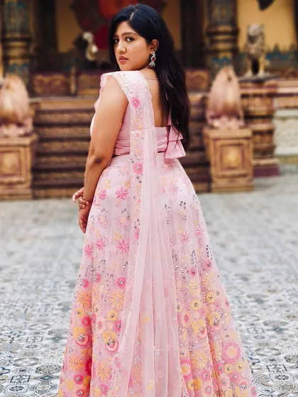 A back view of the pretty pink lehenga, showing how even a simple necklace can complete a look.