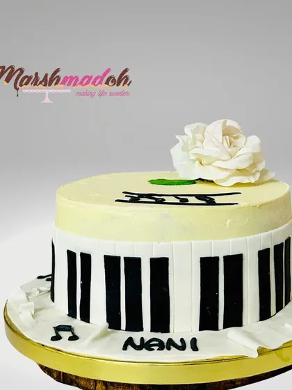A beautiful cake for a mother who loves music, especially the piano. This Classic Chocolate Truffle cake is decorated with fondant piano keys and a delicate, handmade sugar rose.