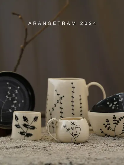 Preeti's collection, "SAADGI," finds joy in life's simplest things. Through her functional tableware, she uses wheel-throwing techniques and delicate carvings on ivory and black clay to capture the beauty in simplicity.