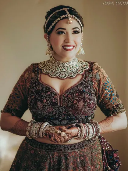 A happy bride showcasing her full look. The traditional updo is perfect for securing her headpiece and veil comfortably for the entire day.