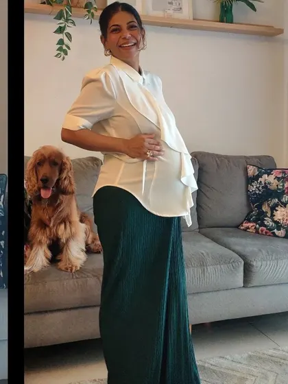 Here I'm showing how a simple ruffle detail on a top can add a touch of feminine style while providing room for the bump. Paired with comfortable wide-leg pants, it's an effortlessly chic maternity look.