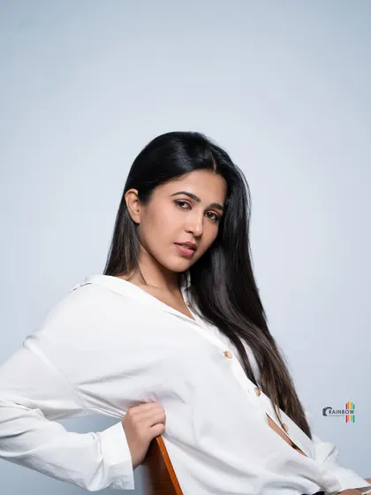 A seated portrait in the white shirt, creating a relaxed and approachable vibe.