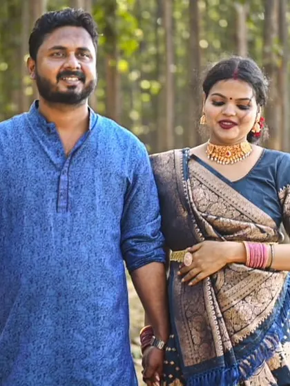 A classic walking shot, capturing the couple's relaxed interaction and the beauty of their coordinated traditional outfits.