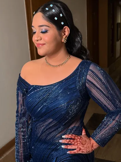 A close-up of the eye makeup, featuring a pop of blue to match the client's stunning dress.