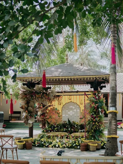 A wider view of the eclectic Haldi setup, showing the seating arrangement and how the unique decor stands out in the venue's courtyard.