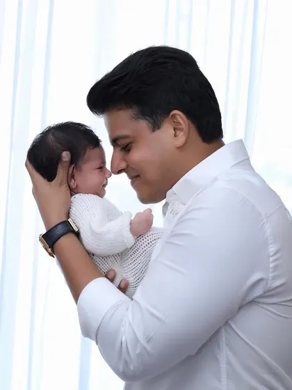 A father shares a tender nose-to-nose moment with his newborn. These unscripted interactions are the heart of our lifestyle newborn photography.