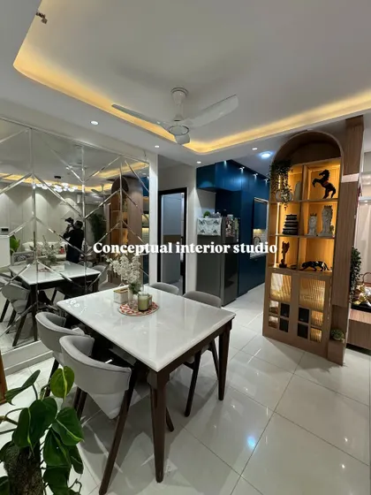A complete view of the dining space, showing how the mirrored wall, wooden crockery unit, and modern dining table come together to create a harmonious design.