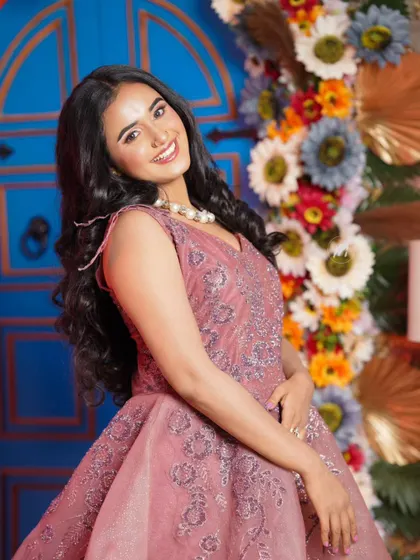 A beautiful shot against a floral background. The makeup is fresh and pretty, perfect for a daytime event.
