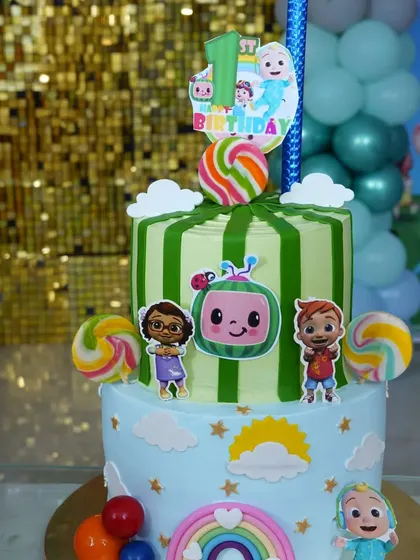 A beautiful Cocomelon-themed cake with character toppers and colorful details.