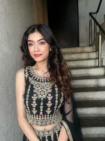 A soft party look with shimmery pink eyeshadow and loose curls, perfect for an evening event.
