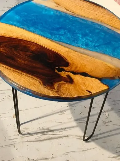 This simple yet elegant river table uses a beautiful blue resin pour to complement the natural grain of the wood. The hairpin legs give it a modern, industrial feel.