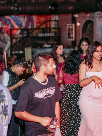 A candid shot of the crowd at an Afrodisiac event. People are mingling, dancing, and soaking in the unique atmosphere that these nights create.