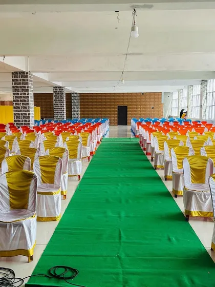 Colorful chair cover arrangements for an event in Chitradurga. We offer different color options for chair covers and sashes to match your event's theme.