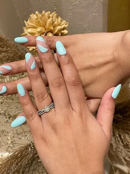 Obsessed with this abstract design in a cool minty blue. The negative space and wavy lines create a fun and modern look.