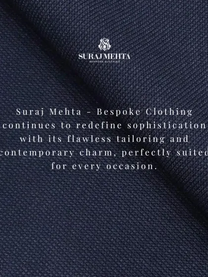A macro shot of a deep navy textured fabric. My work is about redefining sophistication with flawless tailoring and contemporary charm, perfectly suited for every occasion.