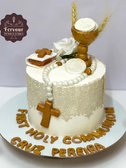 A First Holy Communion cake, designed with reverence and elegance. The cake is decorated with a fondant rosary, Bible, and chalice, with an edible lace wrap for a delicate finish.