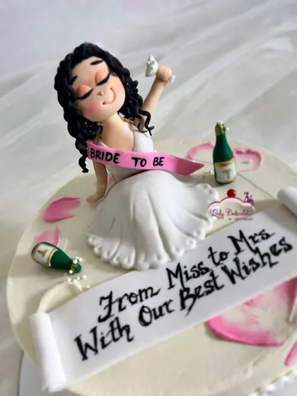 Bride on cloud wine! A fun bachelorette cake with a custom, hand-sculpted sugar figurine of the bride-to-be celebrating her last days as a Miss.