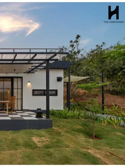 This angle highlights the home's connection to the outdoors, with a covered patio area and sail shade providing comfortable spaces for relaxation. The design is perfect for a weekend retreat.