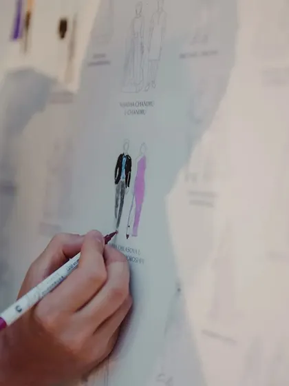 An interactive and personal touch. Guests had fun finding their illustrated selves on this custom guest board and coloring in their outfits, creating a collaborative and colorful memento of the day.