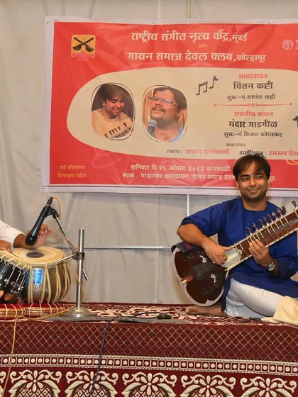 On stage in Kolhapur for a concert organized by NCPA. This is a typical setup for a classical recital, with a simple backdrop to keep the focus on the music.