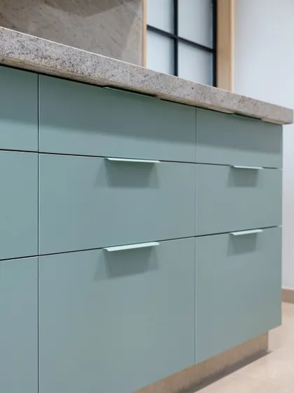 A detail of the mint green drawers, showing the clean lines and simple, elegant hardware. This pastel finish brings a light, airy feel to the kitchen, perfect for creating a space that feels both fresh and modern.