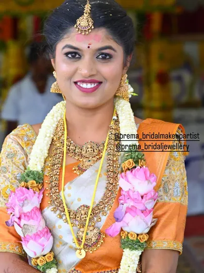 A close-up of the bride's happy face, adorned with a Lakshmi choker and haaram.