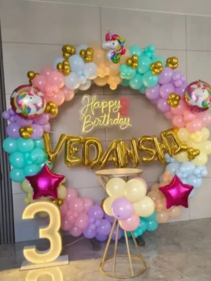 A magical unicorn theme for a 3rd birthday. I used a pastel rainbow balloon ring, unicorn and star foil balloons, a neon sign, and a light-up number '3' to create this enchanting setup.