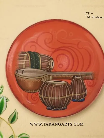 This hand-painted wall plate celebrates the soulful melodies of Carnatic music, featuring instruments like the tabla and sitar. It's a perfect piece for any music lover's home.