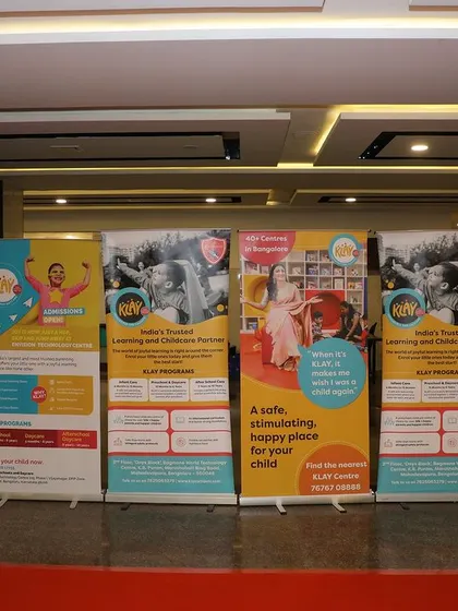 A professional display of roll-up banners and informational standees, providing key details about Klay's programs to the hundreds of families in attendance.
