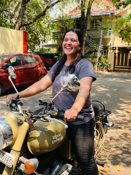 The pure, unadulterated joy of riding. This graduate's laughter captures the essence of the freedom found on two wheels.