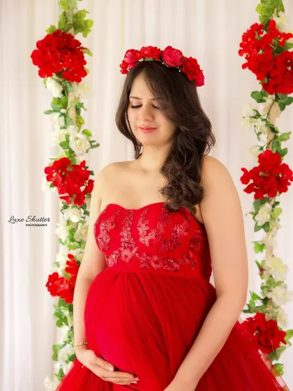 A floral crown is the perfect accessory to complete this romantic, garden-themed look. It beautifully complements the red gown and floral swing.