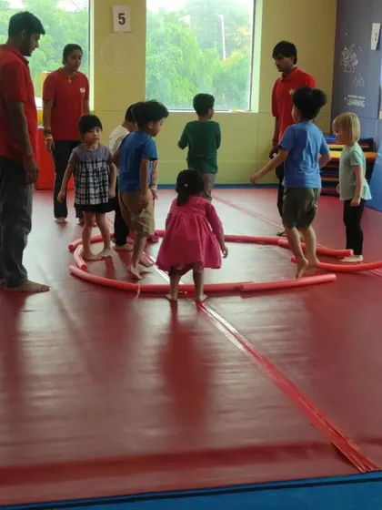 Our instructors leading a game of "giggly wiggly worms" with pool noodles. We structure our games to be inclusive and fun for all age groups.