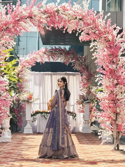 A different angle of the client in the mauve-purple lehenga, showing her looking back elegantly.