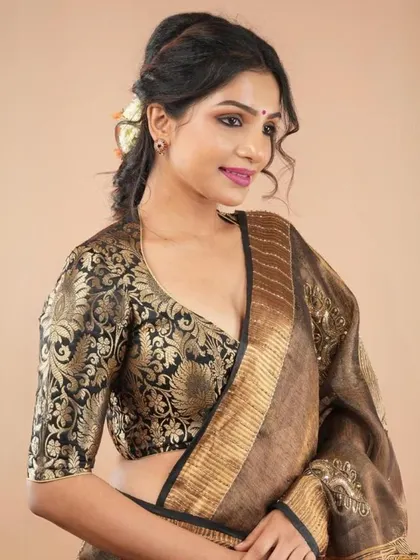 A black and gold brocade blouse with a deep V-neck, offering a rich and luxurious look.