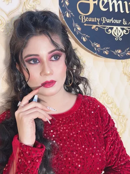 A close-up of the glamorous red party look, showing the dramatic eye makeup.